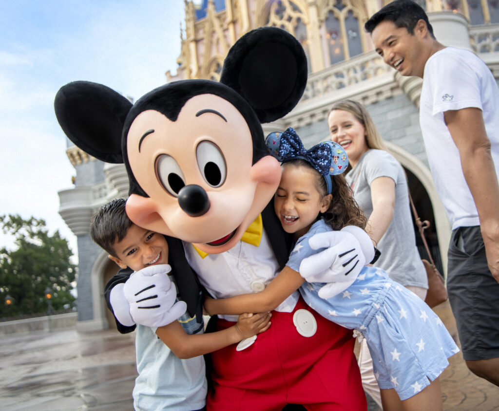 Mickey Mouse hugs a family at Walt Disney World